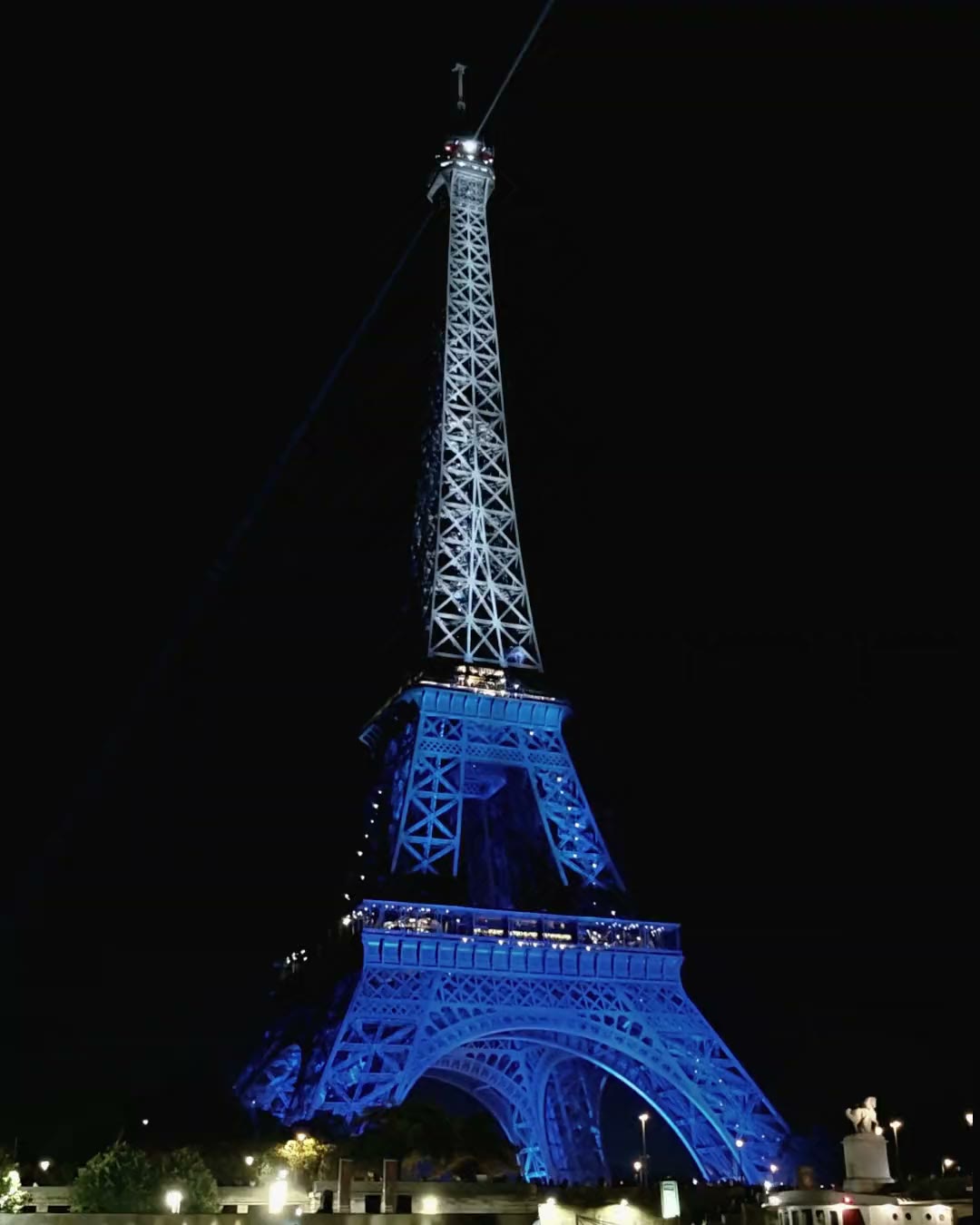 The Eiffel Tower lit blue at night